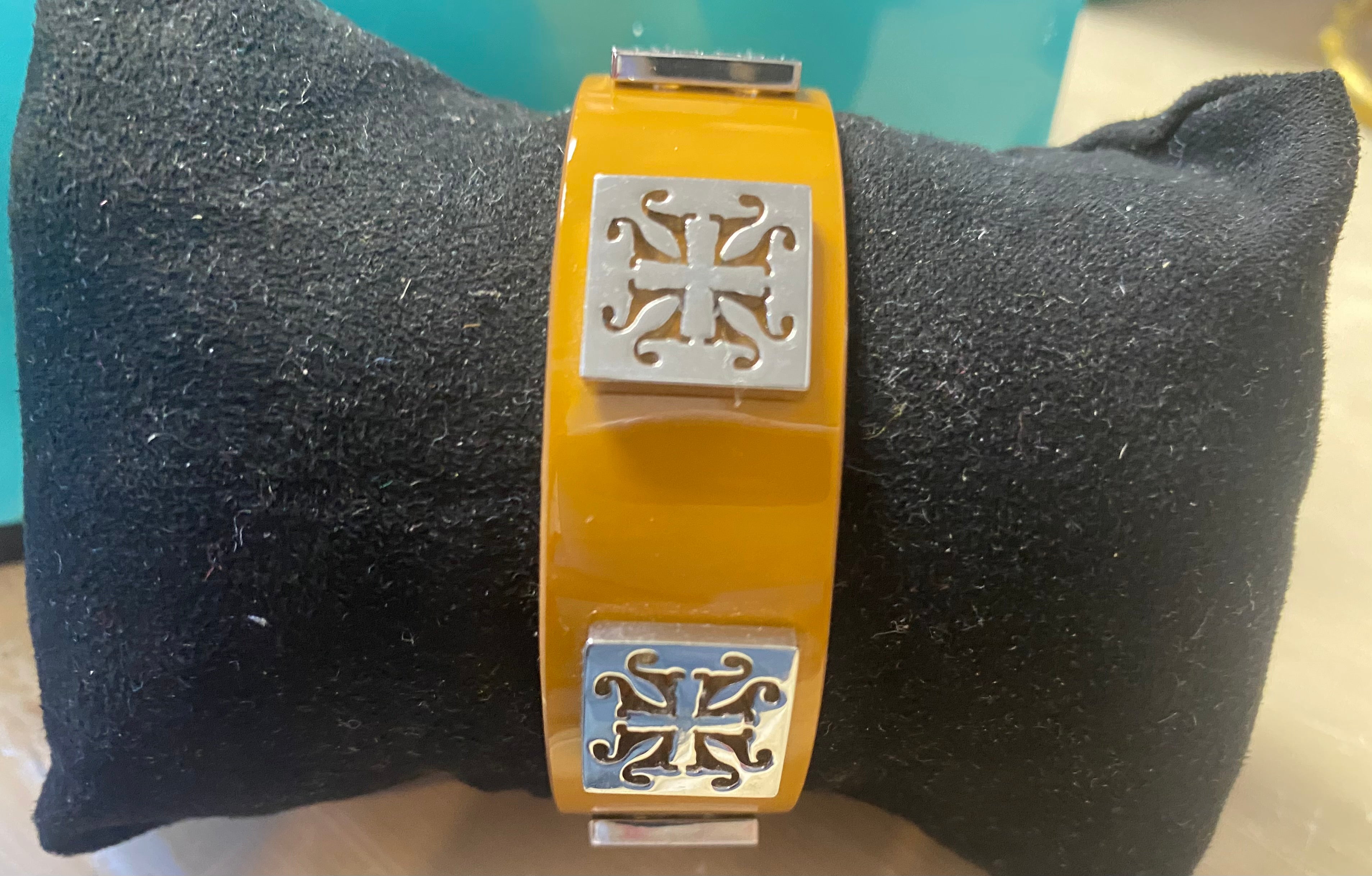 Mustard cuff with square emblem