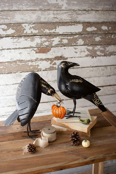 recycled iron crows holding a pumpkin