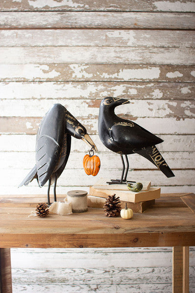 recycled iron crows holding a pumpkin