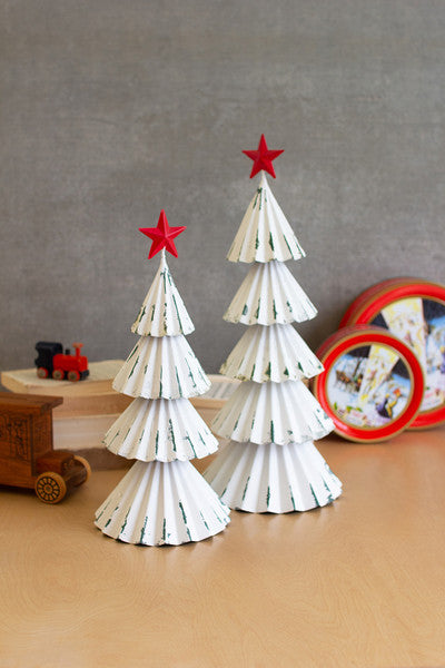 white painted metal christmas trees with red stars