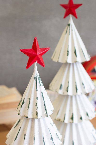 white painted metal christmas trees with red stars